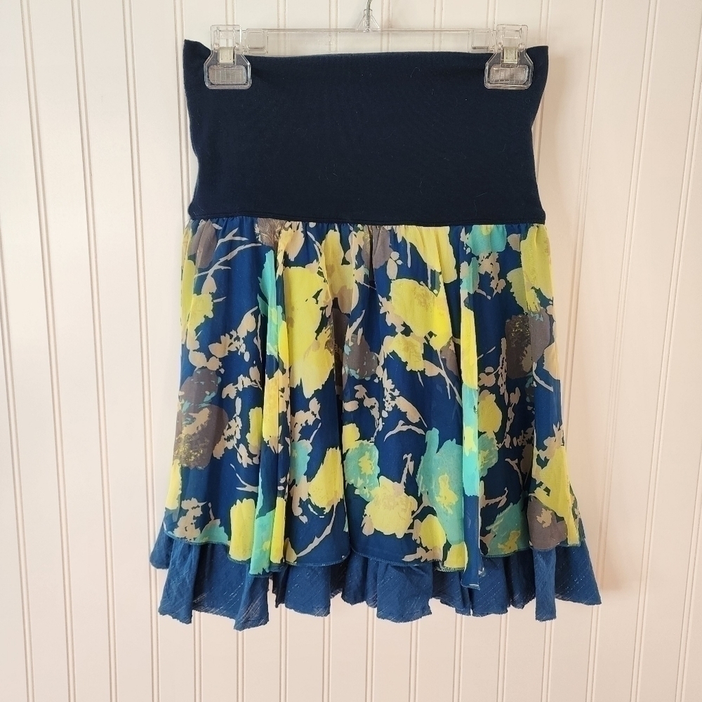 Free people whimsical skirt with multi colored floral pattern top layer is sheer